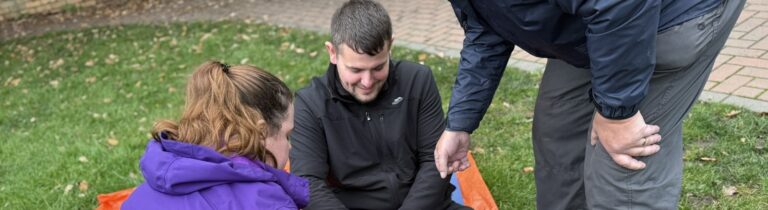 Humberside Scouts volunteers practising first aid outdoors on the grass